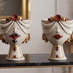 Male and female Zahira heads in antique mother of pearl with gold and lustres, side by side on black marble