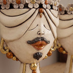 Detail of the male Zahira head with flowers: moustache, goatee and gold earrings