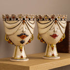 Pair of Zahira heads with flowers in antique mother of pearl with gold and lustres, man and woman, on a shelf