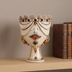 30 cm male Zahira head with flowers, antique mother of pearl with gold, on a shelf beside old books