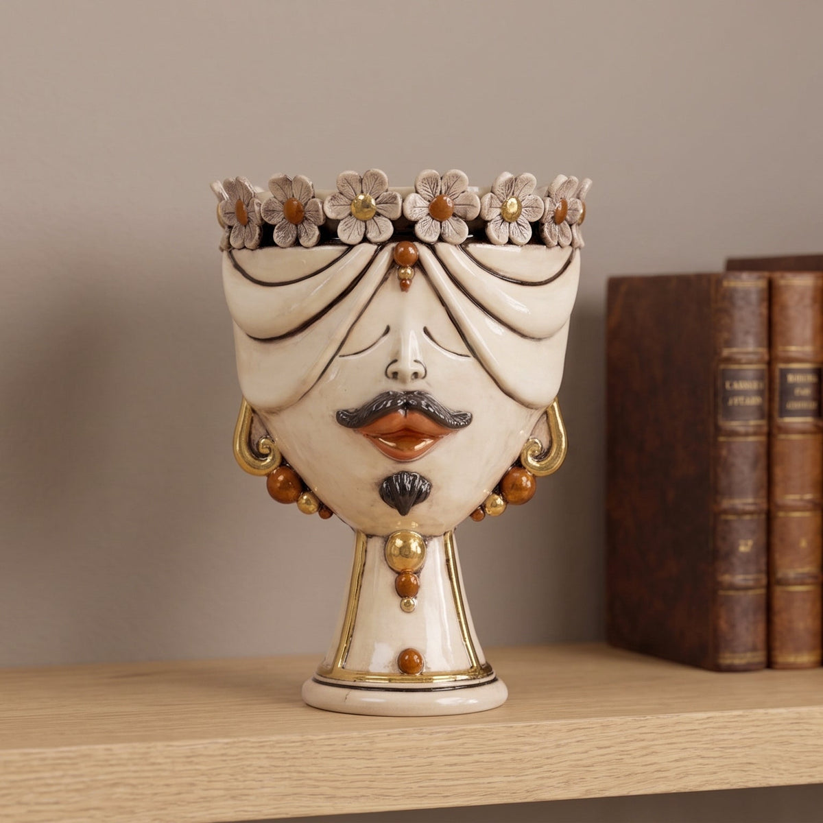 30 cm male Zahira head with flowers, antique mother of pearl with gold, on a shelf beside old books