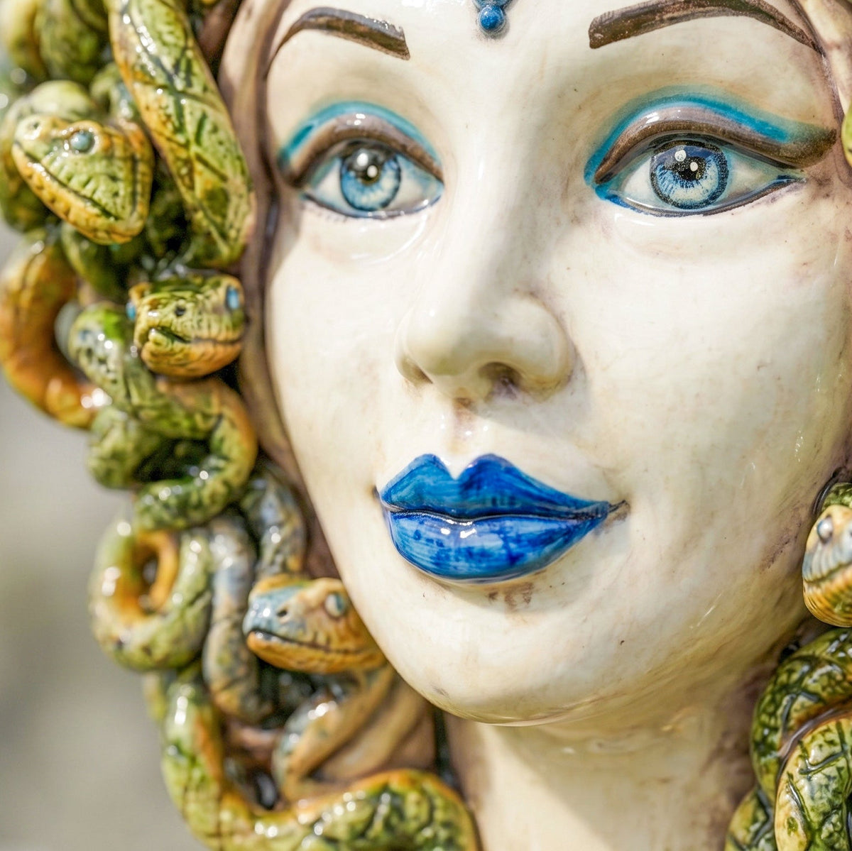 Medusa head, antique mother of pearl, blue beads, hair of snakes. Sicilian ceramics from Caltagirone, Sofia