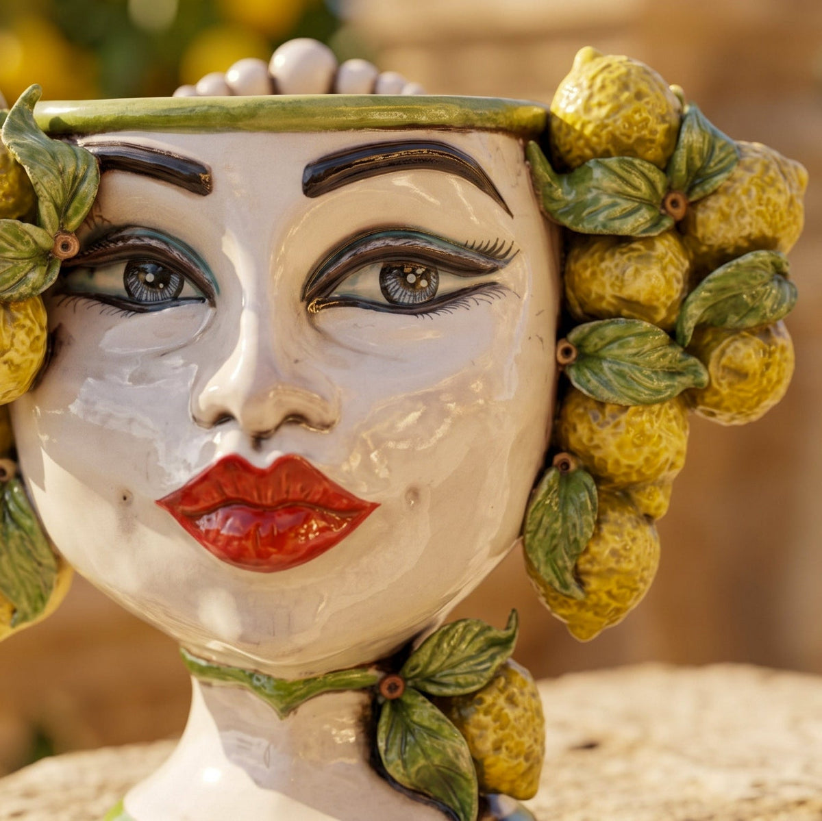 Detail of the 20 cm female Testa di Moro: hand-painted eyes, red lips and lemons in relief