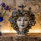30 cm Medusa head with flowers, lit in a stone niche with blue irises