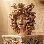 38 cm terracotta Medusa head on a capital, in the warm light of an ancient temple