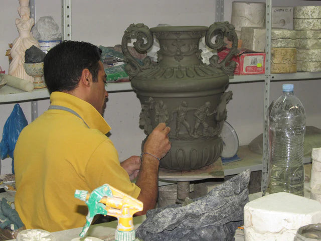 A Sofia workshop ceramicist finishing a large clay vase with relief decoration by hand