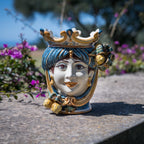 25 cm female Testa di Moro with lemons in blue and orange, on a wall among bougainvillea