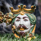 Handmade Caltagirone ceramics: regal face with crown and colourful details, traditional Sicilian art