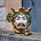 Handmade Caltagirone ceramics with regal face and colourful crown, traditional Sicilian art