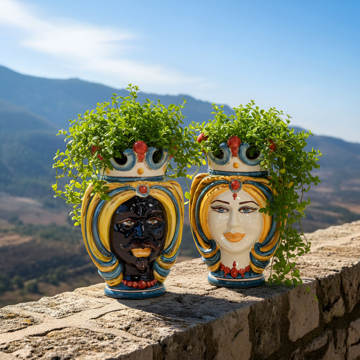 Pair of Teste di Moro with turban, Decoro Sicily, man and woman planted with greenery, on a hillside wall