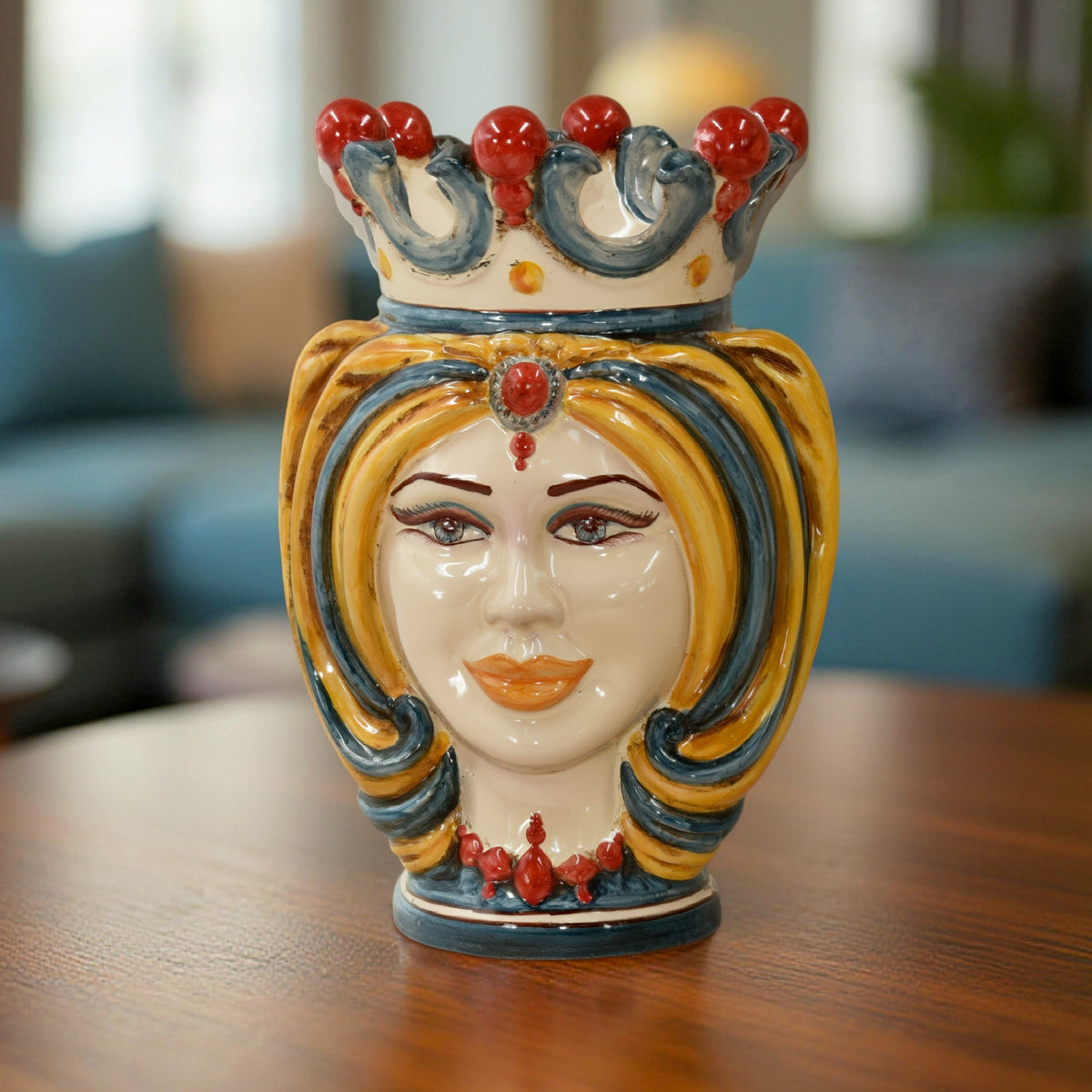 Female Testa di Moro with blue and yellow turban and a crown with red beads, on a wooden table
