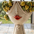 Detail of the female Zahira head: lemons and leaves in relief on the brow, red lips