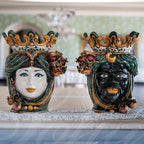 Handmade Caltagirone ceramics: regal faces with crowns and colourful details, traditional Sicilian art