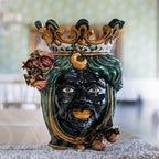 Handmade Caltagirone ceramics with a black face, crown and pomegranates, traditional Sicilian art